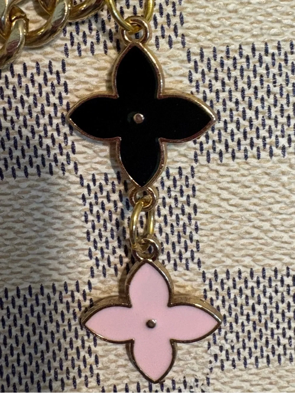 Authentic Louis Vuitton Lock Charm and other unbranded charms on bag chain